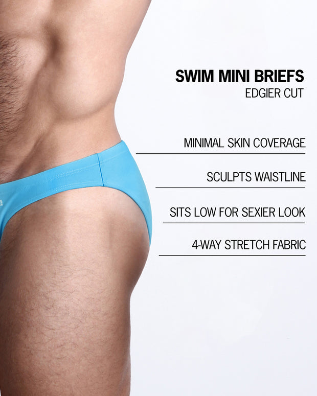 Infographic explaining the features of the MAGNET BLUE Swim Mini Brief made by BANG! Clothes. These edgier cut mens swimsuit are minimal skin coverage, sculpts waistline, sits low for sexier look, and 4-way stretch fabric.