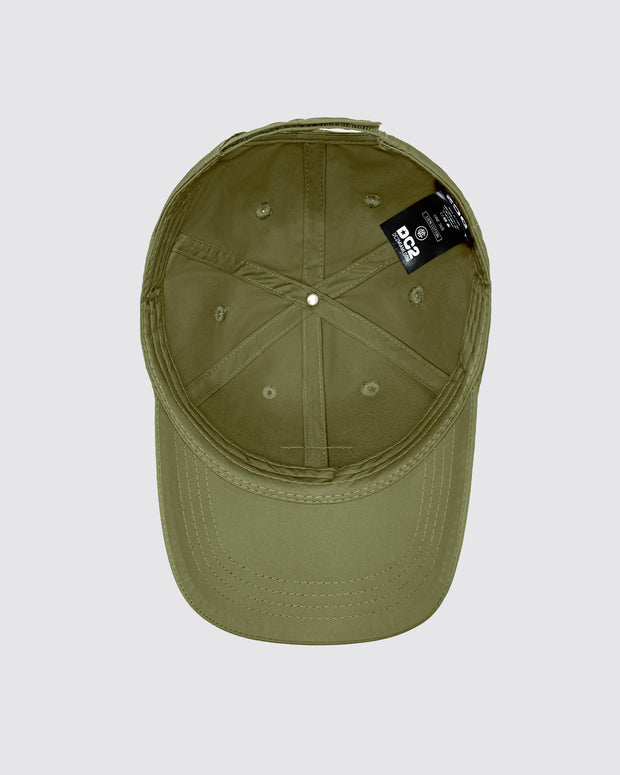 Overhead view of the inside of the MAGNUM GREEN Chillax baseball cap. The cap is crafted from durable green fabric with a soft inner band for a comfortable fit. Visible stitching lines and a branded label from DC2 Miami, making it an ideal accessory for casual wear and street style