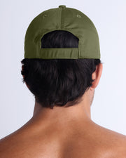 The MAGNUM GREEN Chillax Cap, modeled here, is in deep green. Its adjustable velcro strap at the back ensures a perfect fit for any head size.
