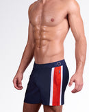 DC2 Miami Maritime Tailored Shorts — side view highlighting navy tailored shorts with red and white stripe panel and adjustable side buckle detail.
