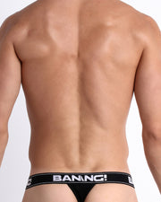 Back view of model wearing the MAX WHITE from the Retro line Men’s breathable cotton thongs for men by BANG! Ideal choice when you want to avoid visible underwear lines.
