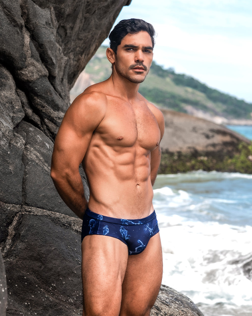DC2 Mermen Masters Swim Brief — model wearing navy swim brief featuring an aquatic-inspired print of illustrated mermen and sea motifs, crafted from quick-dry stretch fabric for a bold, oceanic statement.