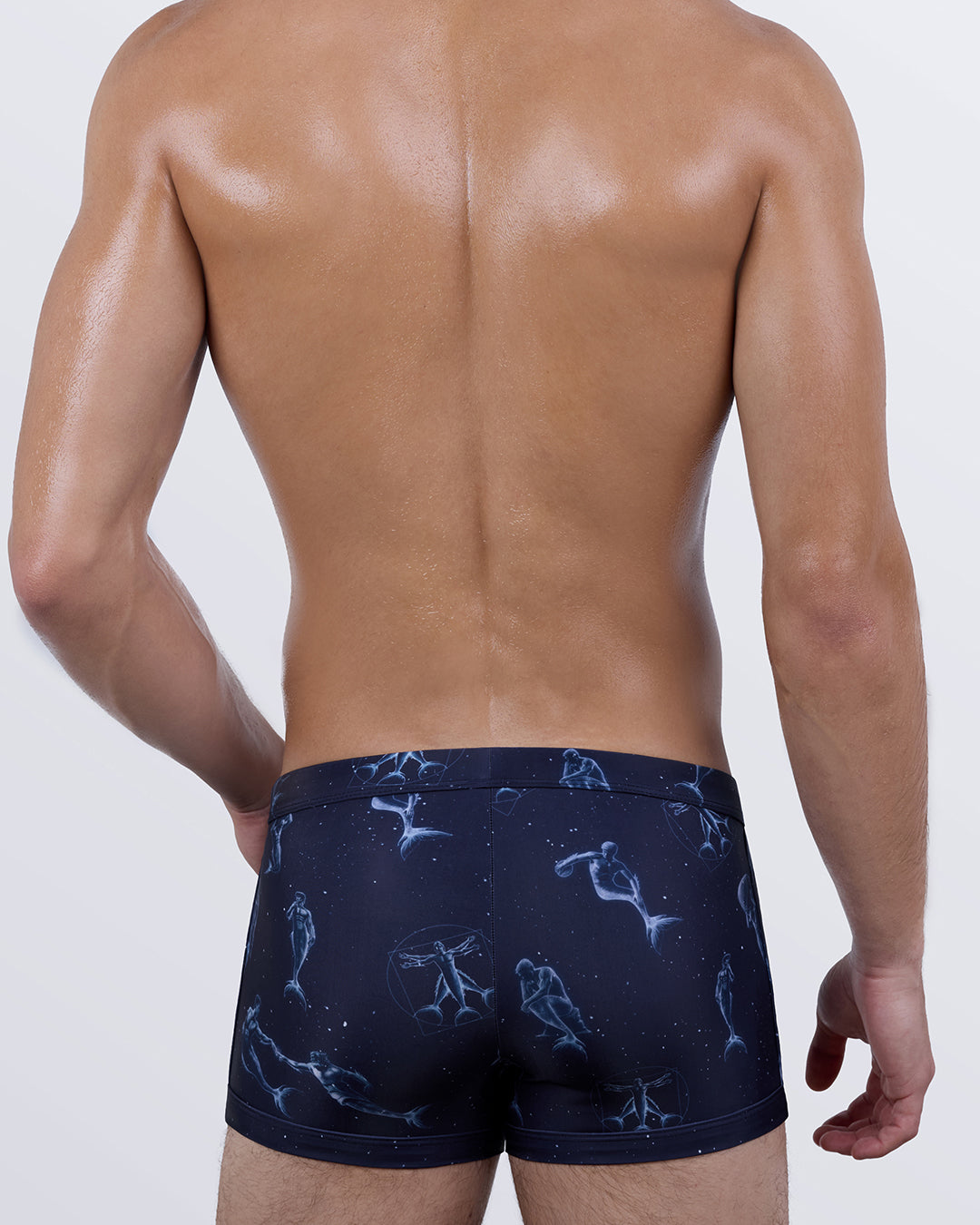Back view of the MERMEN MASTERS Swim Trunks – celestial-inspired print with floating mermen, Vitruvian Man details, and an art-meets-ocean aesthetic.