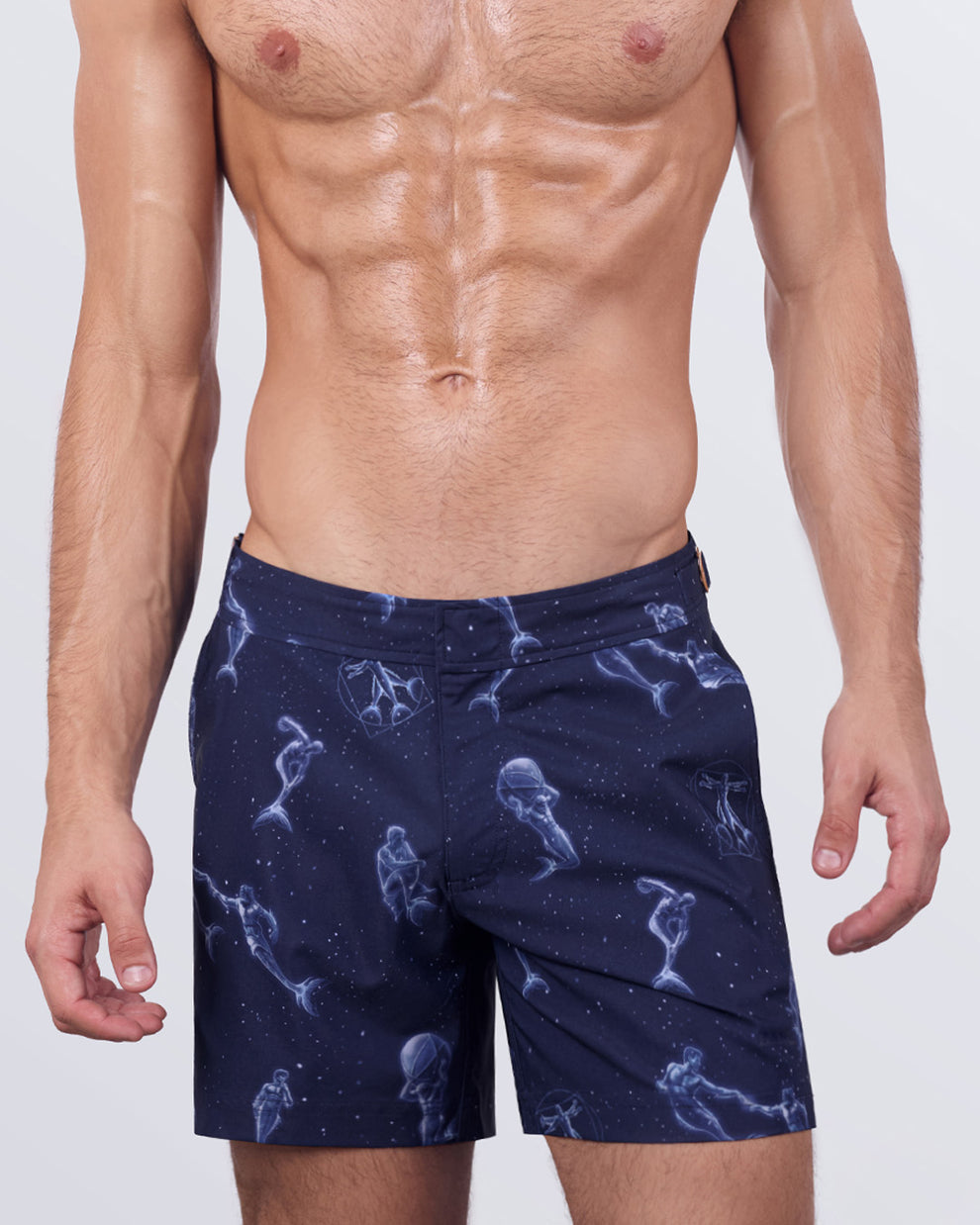 View of a male model in the MERMEN MASTERS - Tailored Shorts by BANG! Miami. The adjustable side buckles provide a customized fit, while the tailored cut ensures a modern, form-fitting silhouette that transitions effortlessly from the beach to casual outings.