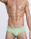 DC2 MISS YOU MUCH — model wearing MISS YOU MUCH Modal Briefs, featuring soft mint green color and contrast waistband with white piping.