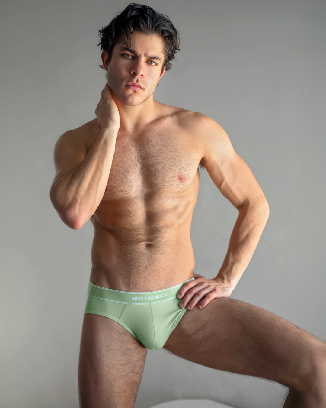 Model wearing DC2 Miss You Much Modal Briefs in soft mint green, showcasing a sleek low-rise fit and minimalist waistband design.