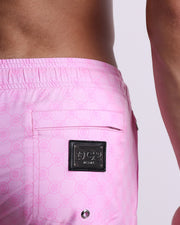 Close-upview of the MONO PINK men's Poolside Shorts, showing the zippered back pocket with the DC2 logo in silver, designed by DC2. 
