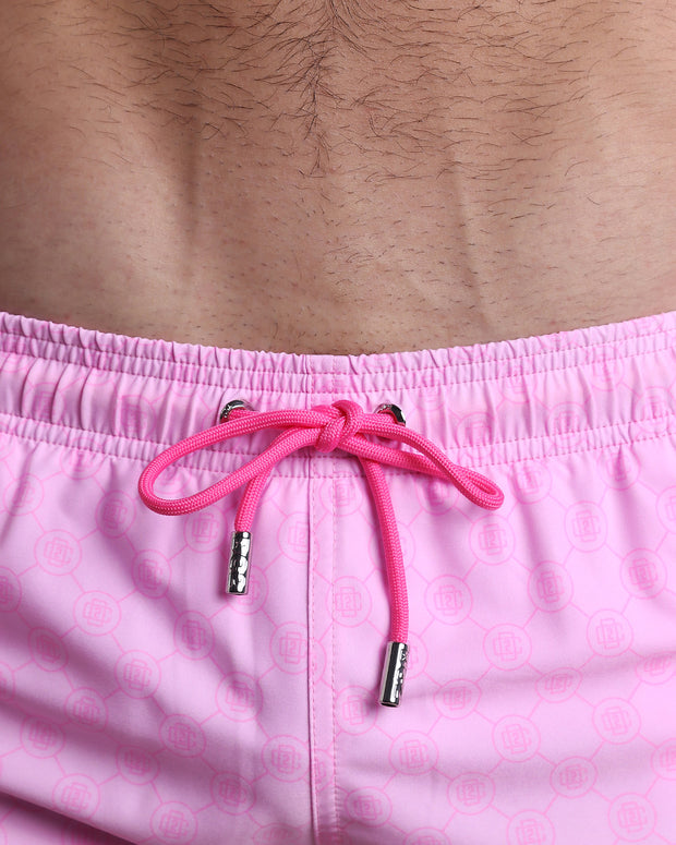 Close-up view of the MONO PINK men’s summer shorts, showing pink cord with custom branded silver cord ends, and matching custom eyelet trims in silver.