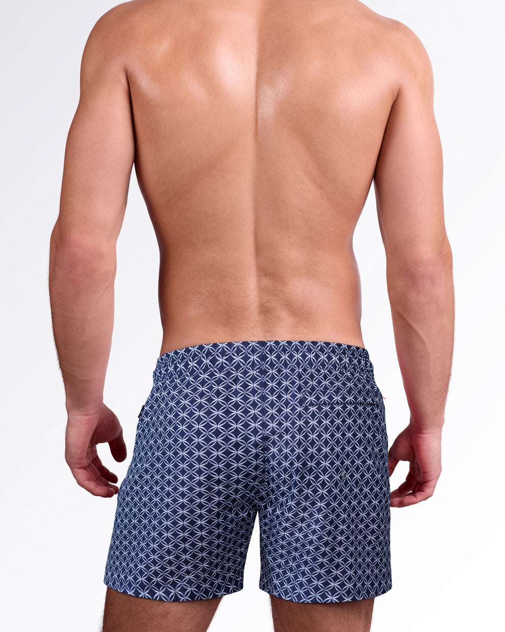 Back view of Mono Waves Blue Resort Shorts showcasing the navy geometric wave print, rear pocket, and relaxed resort swim fit.