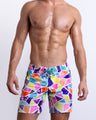 Male model wearing MOSAIC Flex Boardshorts, premium beachwear with a stylish multi-color mosaic shape print. These high-quality swimwear bottoms by BANG! Clothes, a men’s beachwear brand from Miami.