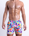 Male model wearing MOSAIC, premium swimwear with a stylish multi-color mosaic shape design for men. These high-quality swimwear bottoms by BANG! Clothes, a men’s beachwear brand from Miami.