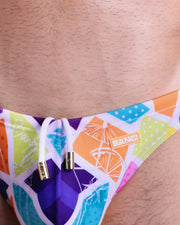 Close-up view of the MOSAIC men’s drawstring briefs showing white cord with custom branded golden cord ends, and matching custom eyelet trims in gold.
