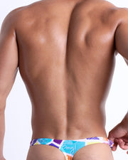 Back view of the MOSAIC men’s beach swim bikini in a retro abstract colorful mosaic pattern, designed by BANG! Clothes in Miami.