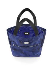 Top view of the NAVY BLUE CAMO Poolside Tote Bag by DC2 Miami, showcasing the spacious interior with a visible DC2 Miami logo label. The bag features a blue camouflage pattern with sturdy black handles and multiple zippered compartments for secure storage.