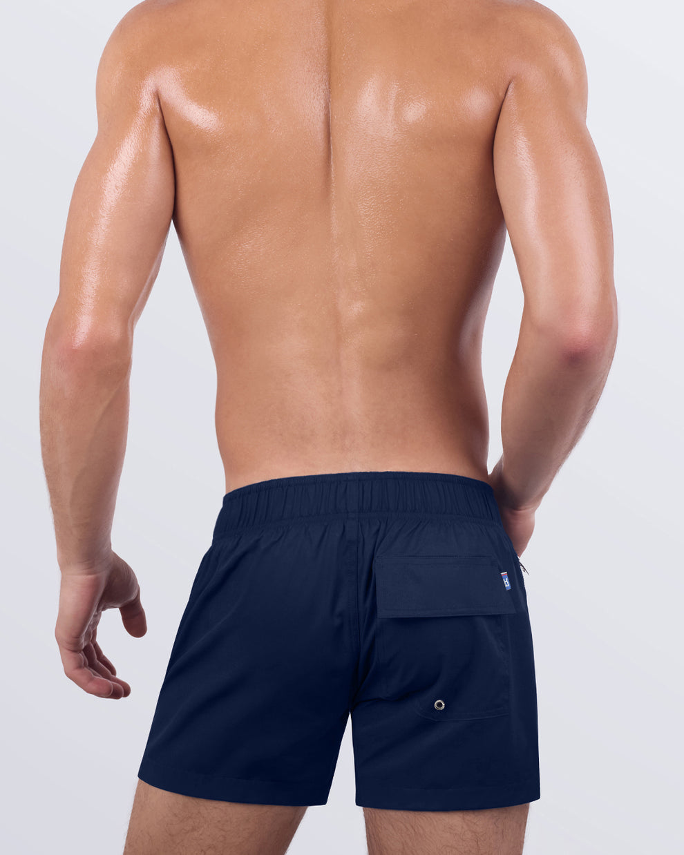 Back view of the NAVY BOOMER - Flex Shorts, showcasing the secure back pocket with a signature logo patch, along with an elasticated waistband for enhanced comfort.