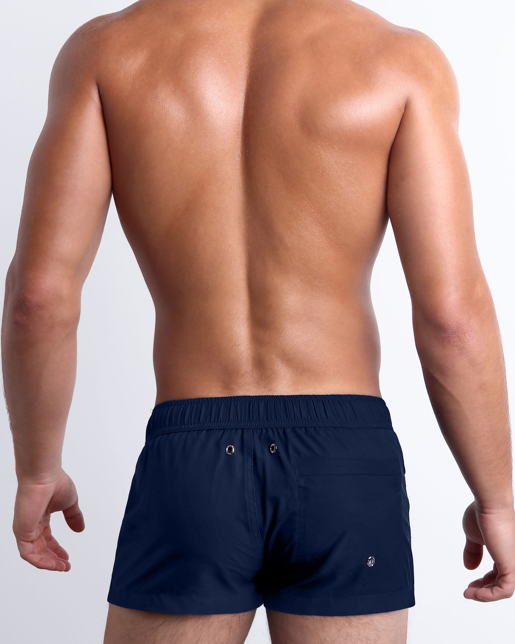 Back view of Navy Boomer Mini Shorts showcasing the clean navy design, rear pocket, and streamlined fit for versatile beach and resort wear.