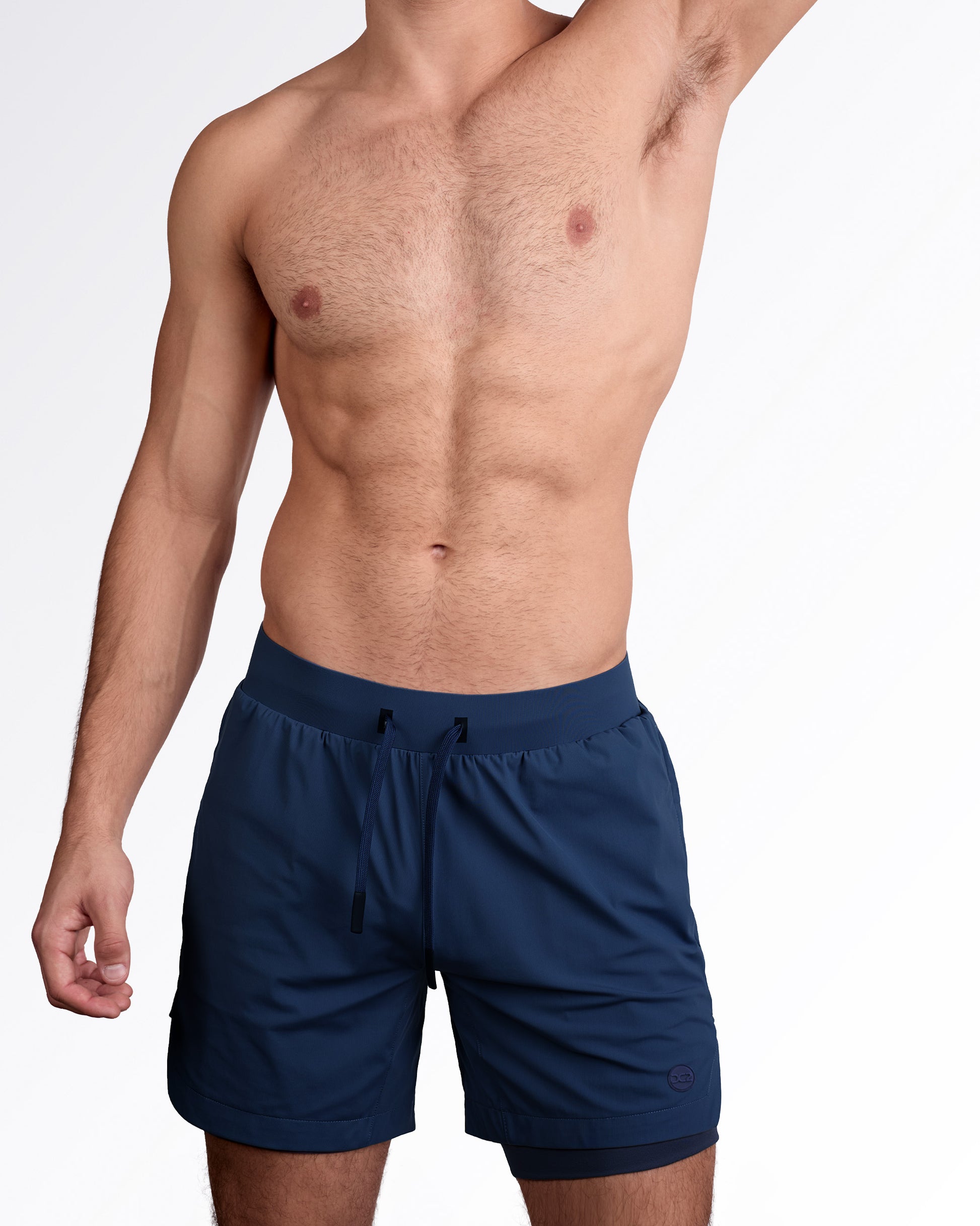 Man wearing lined gym workout shorts in navy blue color from DC2 Miami fitness menswear.