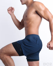 Side view of men’s performance exercise shorts in a solid blue color made made by DC2 the official brand of mens sportswear.