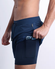 Side view of men’s triaining in a solid blue color with interior compression phone pocket made made by DC2 the official brand of mens sportswear.