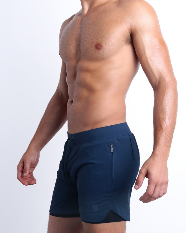 Side view of men’s performance exercise shorts in a solid blue color made made by DC2 the official brand of mens sportswear.