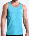 BANG! Miami Olympic Blue Tank Top — model wearing fitted tank in Olympic blue, soft stretch fabric with scoop neckline and minimal chest logo.