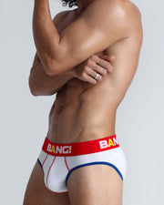 Side view of model wearing the OVATION soft cotton underwear with a white buttery-soft elastic waitband with the BANG! Logo in white and yellow for men by BANG! Miami the official brand of men's underwear.
