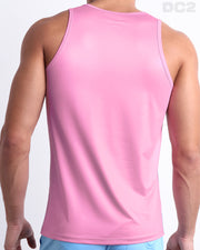 Male model wearing the men's PADAM PINK beach quick-dry tank top for men features a in a solid pink color, made by DC2 a capsule brand by BANG! Clothes in Miami.