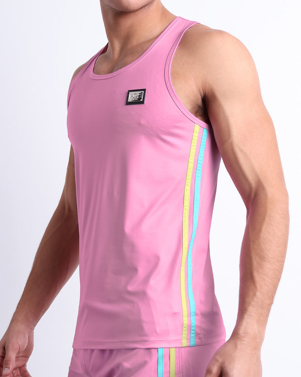 Male model wearing PADAM PINK men’s casual Tank Top. A premium quality top in a solid light pink color with pale yellow and aqua-blue stripes on the sides, a men’s beachwear brand from Miami.