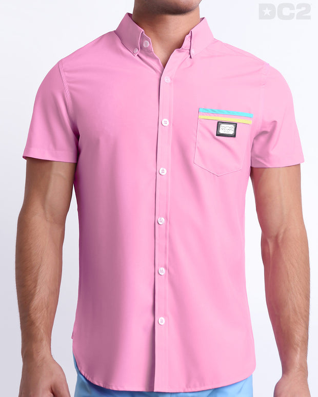This is a front view of a male model looking sexy in a PADAM PINK stretch shirt for men. The shirt is light pink with yellow and aqua-colored stripes on the left pocket. It&