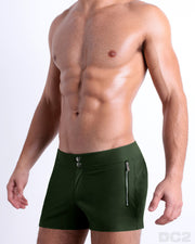 Side view of the PALM GREEN Summer Beach Shorts with dual zippered pockets for men featuring a solid green color is designed by BANG! Clothes in Miami.