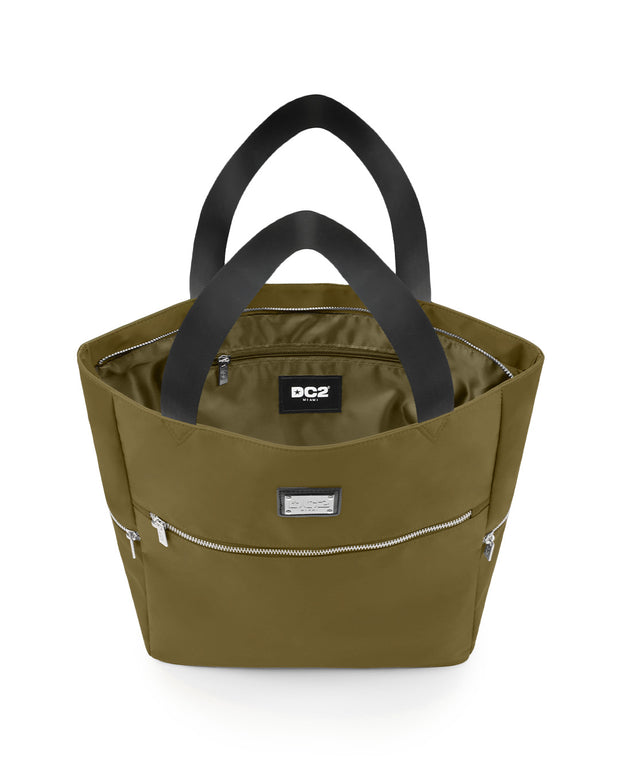 Top view of the PALM GREEN Poolside Tote Bag by DC2 Miami, showcasing the spacious interior with a visible DC2 Miami logo label. The bag features a green color with sturdy black handles and multiple zippered compartments for secure storage.