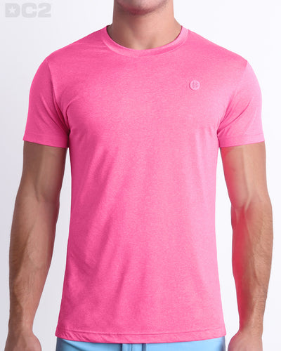 Frontal view of male Model wearing the PINKTENSITY in a solid bright vibrant pink quick-dry short-sleeve shirt. Designed by DC2 a BANG! Miami Clothes capsule brand.