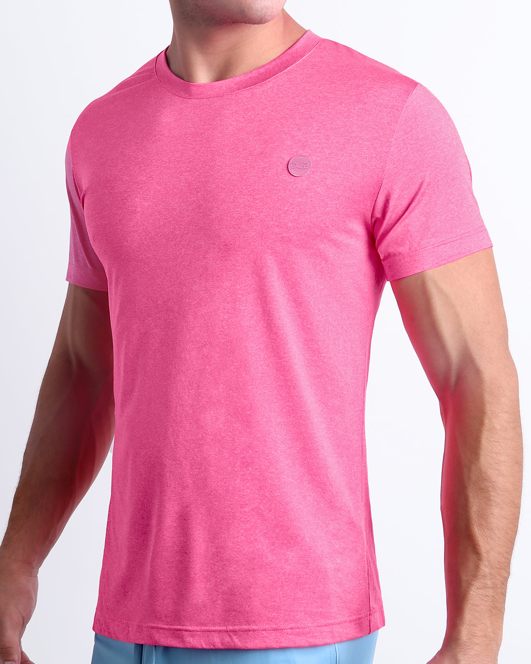 Model wearing the Pinktensity Workout T-Shirt featuring a lightweight stretch fabric, athletic cut, and tonal embroidered DC2 logo.