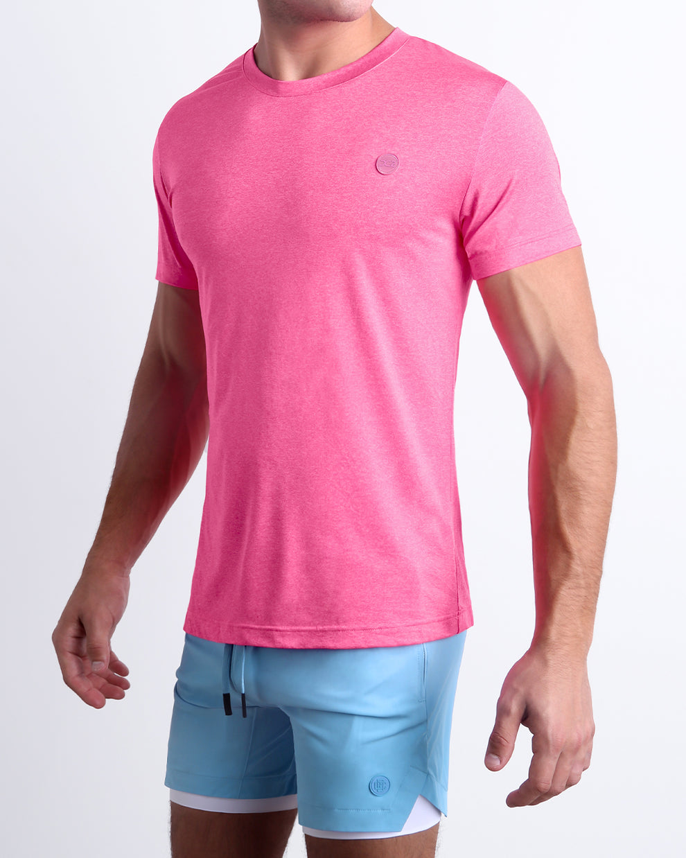 Model wearing the Pinktensity Workout T-Shirt paired with light blue training shorts, highlighting its flexible fit for gym workouts and active wear.
