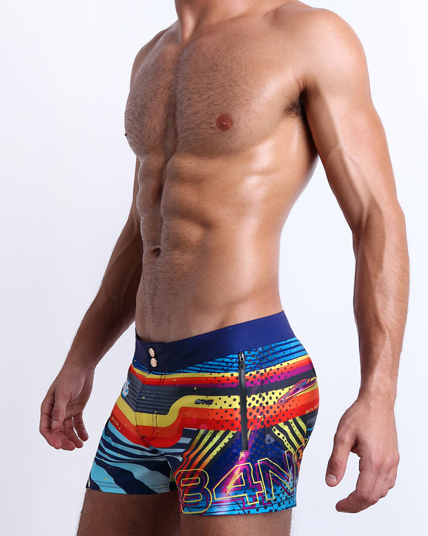Side view of the POOL POSITION Summer Beach Shorts with dual zippered pockets for men featuring a colorful design that pays homage to motorsports and Grand Prix racing, designed by BANG! Clothes in Miami.