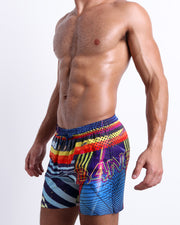 Side view of the POOL POSITION Summer resort shorts with dual pockets for men featuring a colorful design that pays homage to motorsports and Grand Prix racing, designed by BANG! Clothes in Miami.
