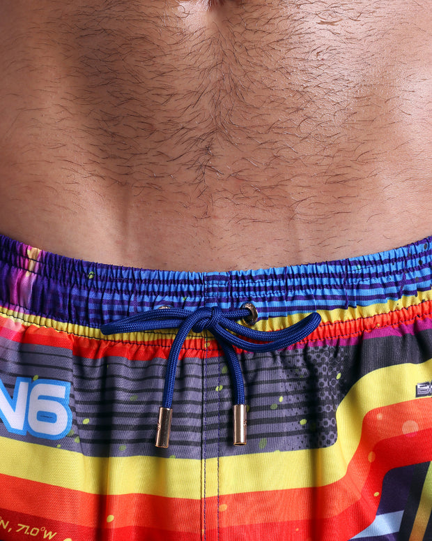 Close-up view of inseam and details of POOL POSITION swimsuit for men, with blue cord and custom branded golden cord-ends, and matching custom eyelet trims in gold.