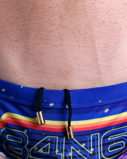 Close-up view of the POOL POSITION men’s drawstring briefs showing black cord with custom branded golden cord ends, and matching custom eyelet trims in gold.
