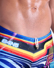 Close-up view of the POOL POSITION men’s drawstring briefs showing white cord with custom branded golden cord ends, and matching custom eyelet trims in gold.