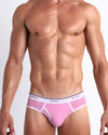 Front view of a sexy male model wearing a BANG! cotton briefs for men in the PRIVATE PINK a pink color offering a perfect fit in a retro that sits low for a contemporary fit. 