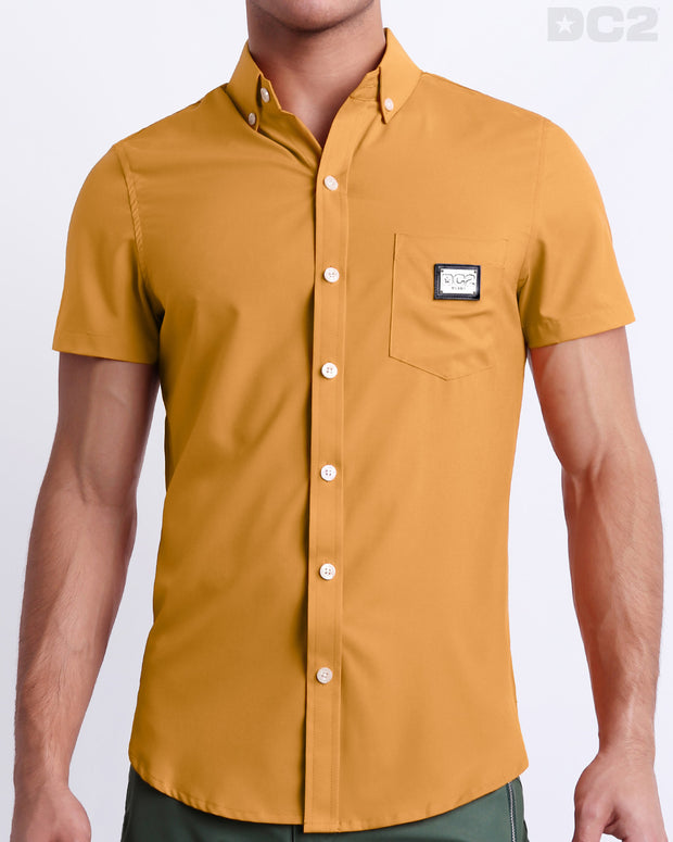 This is a front view of a male model looking sexy in a RETRO MUSTARD stretch shirt for men. The shirt is a solid mustard yellow color on the left pocket. It&