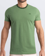 Frontal view of a male model wearing a light green Pima cotton t-shirt with a bold forest green collar, crafted for stylish casual wear and beachwear by DC2 Miami. Premium quality men's streetwear t-shirt, perfect fit for summer fashion.