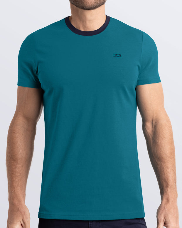 Frontal view of a male model wearing a rich teal Pima cotton t-shirt with a bold navy blue collar, crafted for stylish casual wear and beachwear by DC2 Miami. Premium quality men&