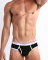 Front view of a sexy male model wearing a BANG! cotton briefs for men in the RISKY BLACK offering a perfect fit in a retro that sits low for a contemporary fit. 