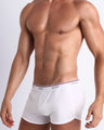 Side view of a sexy male model wearing the RISKY BLACK BANG! Cotton Boxer Briefs for men in a solid white color. Flatlock seams prevents chafing.