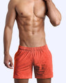 Frontal view of male model wearing the ROCKY ORANGE jogger shorts in a heathered orange quick-dry by the Bang! brand of men's beachwear from Miami.