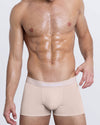DC2 SIMPLY IRRESISTIBLE — model wearing nude pink modal boxer briefs with soft-touch waistband featuring “SIMPLY IRRESISTIBLE” text. Comfortable, flattering men's underwear.
