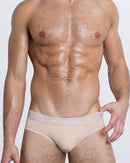 DC2 Simply Irresistible Modal Brief — model wearing tan cotton brief underwear, featuring a low-rise cut and slogan waistband.
