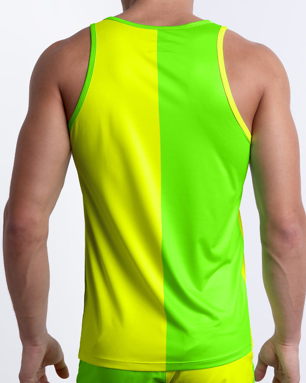 Back view of a male model wearing men’s SINGLE BILINGUAL (NEON YELLOW/GREEN) beach Tank Top in a bright fluorescent yellow and green color block design made by BANG! Clothes in Miami.