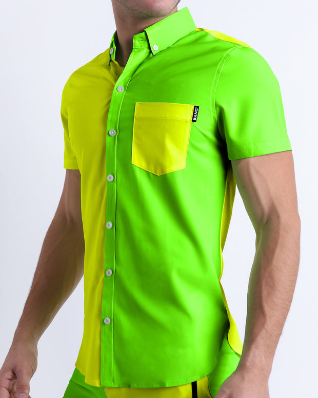 Male model wearing SINGLE BILINGUAL (NEON YELLOW/GREEN) men’s sleeveless stretch shirt. A premium quality top with a stylish color block design in bright neon yellow and lime green colors for men, a men’s beachwear brand from Miami.